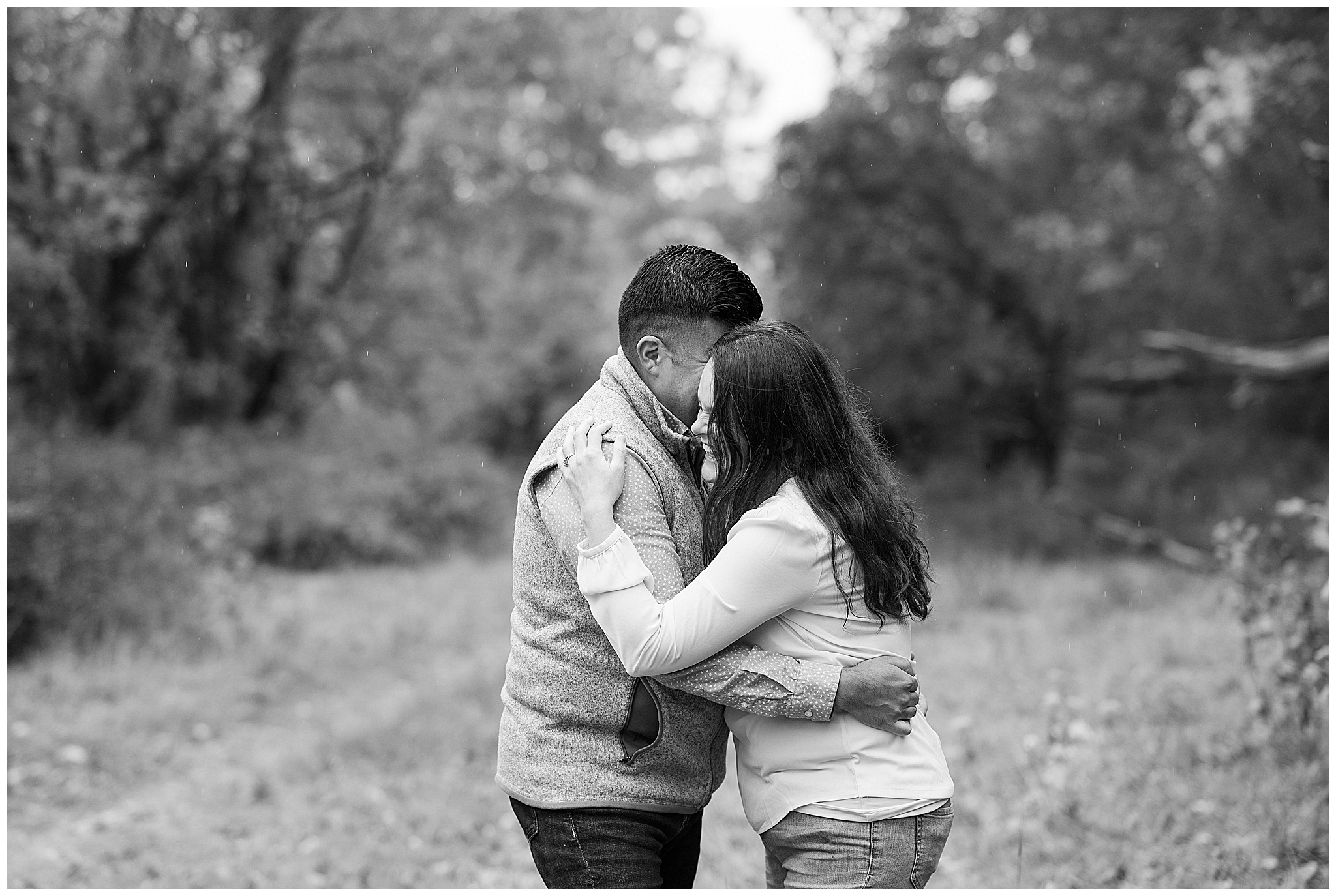 Couple embracing in black and white image.