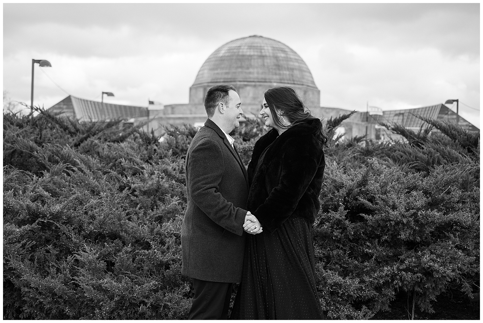 Black and white engagement photo at Adler planetarium