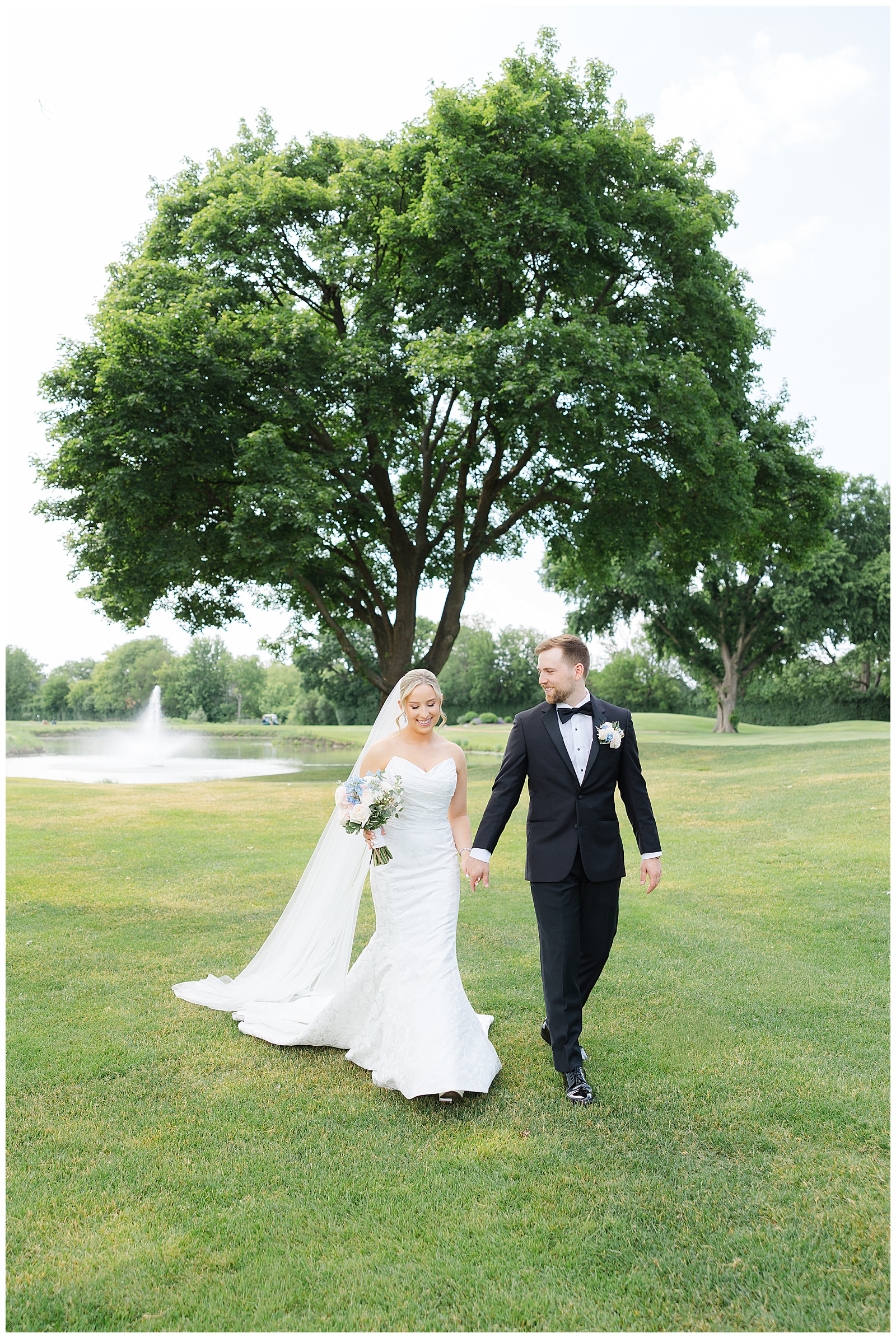 Bride and groom walking hand in hand during their Chevy Chase Country Club wedding in Wheeling, Illinois.
